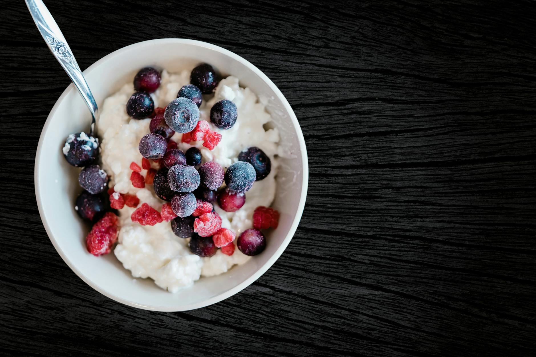 Enjoy a healthy breakfast with cottage cheese topped with fresh berries, perfect for a nutritious start.